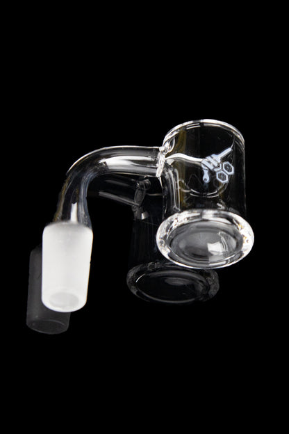 Clear glass dab rig with a quartz insert against a black background.
