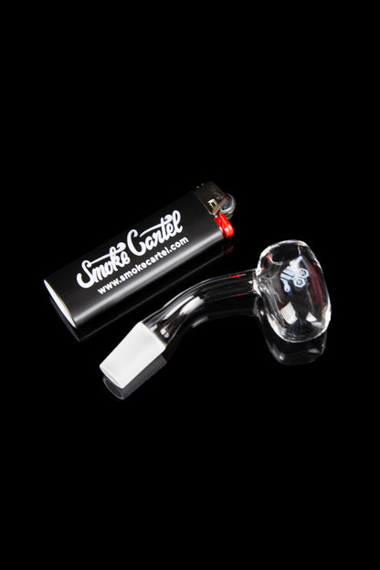 Glass bubbler pipe and accessories on a black background.
