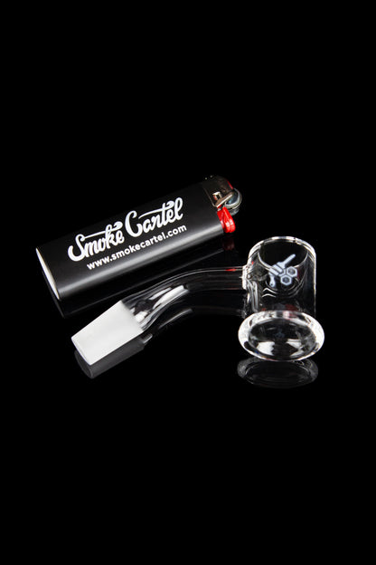 Glass bubbler pipe and accessories displayed on a black reflective surface with branded packaging.