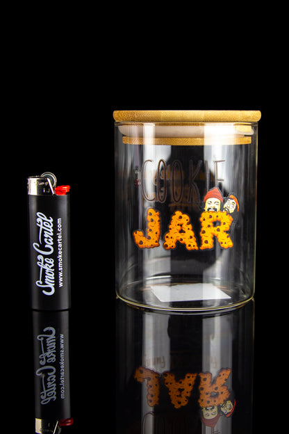 Glass jar labeled “Cookie Jar” filled with cannabis buds beside a branded lighter, reflected on a shiny surface.