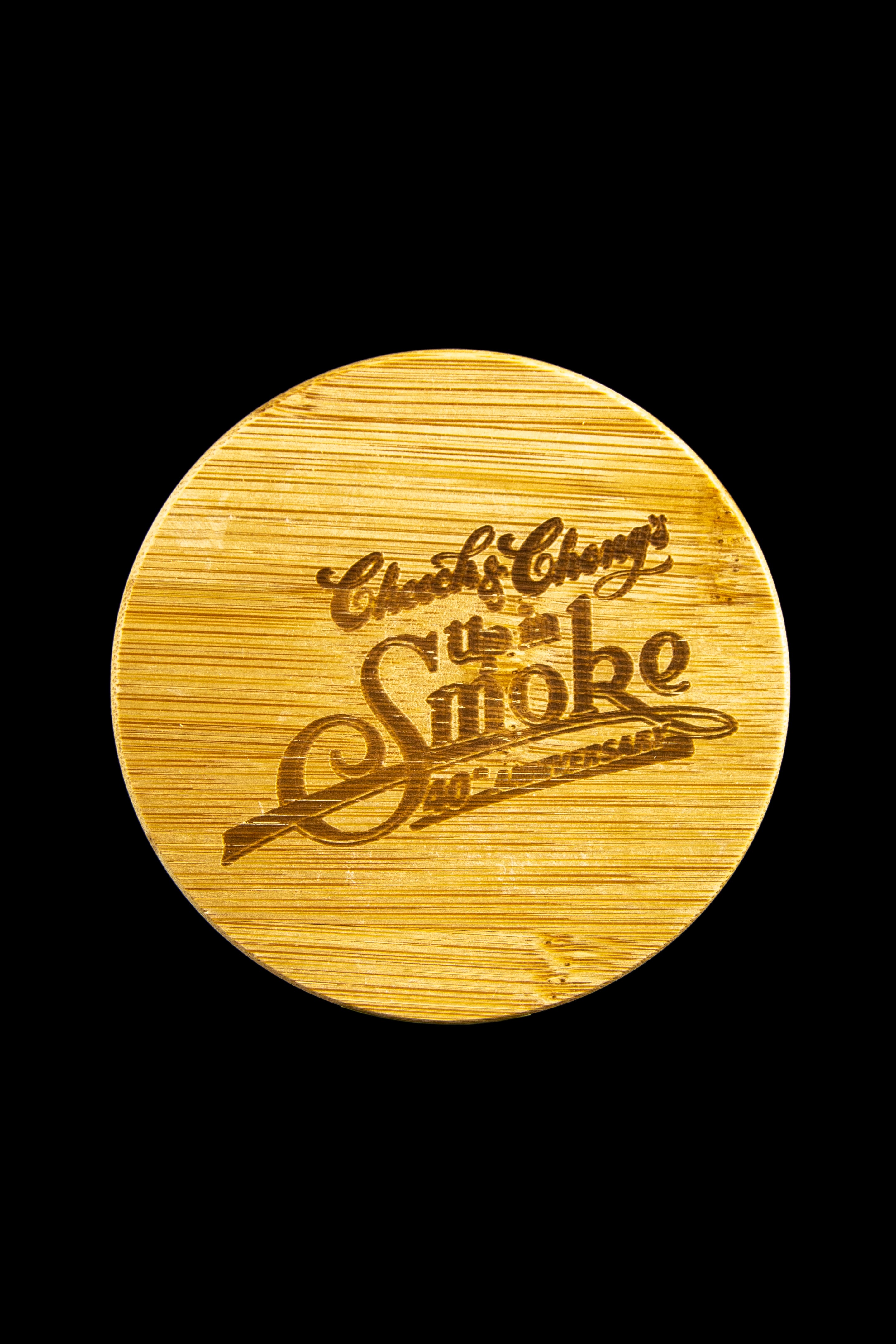 Wooden coaster engraved with "Cheech & Chong's Up in Smoke" and cannabis leaf designs.