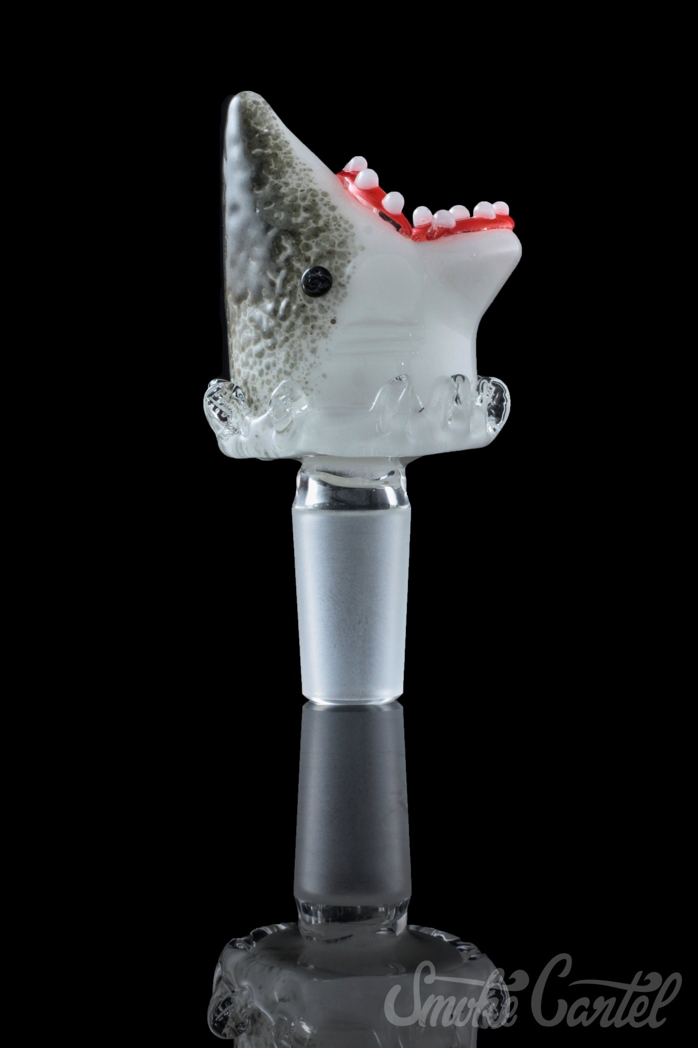 A studio shot displays the Empire Glassworks "Jawsome" Bowl Piece, a shark-shaped glass piece reflecting on a dark surface.