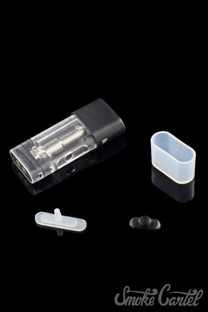 A close-up shot of the Kandy Pens RUBI 1ml Pod laying on a black surface, angled slightly from above.