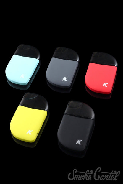 Front view of the Kandy Pens Feather Compact Vaporizer in black, resting on a dark, reflective surface.