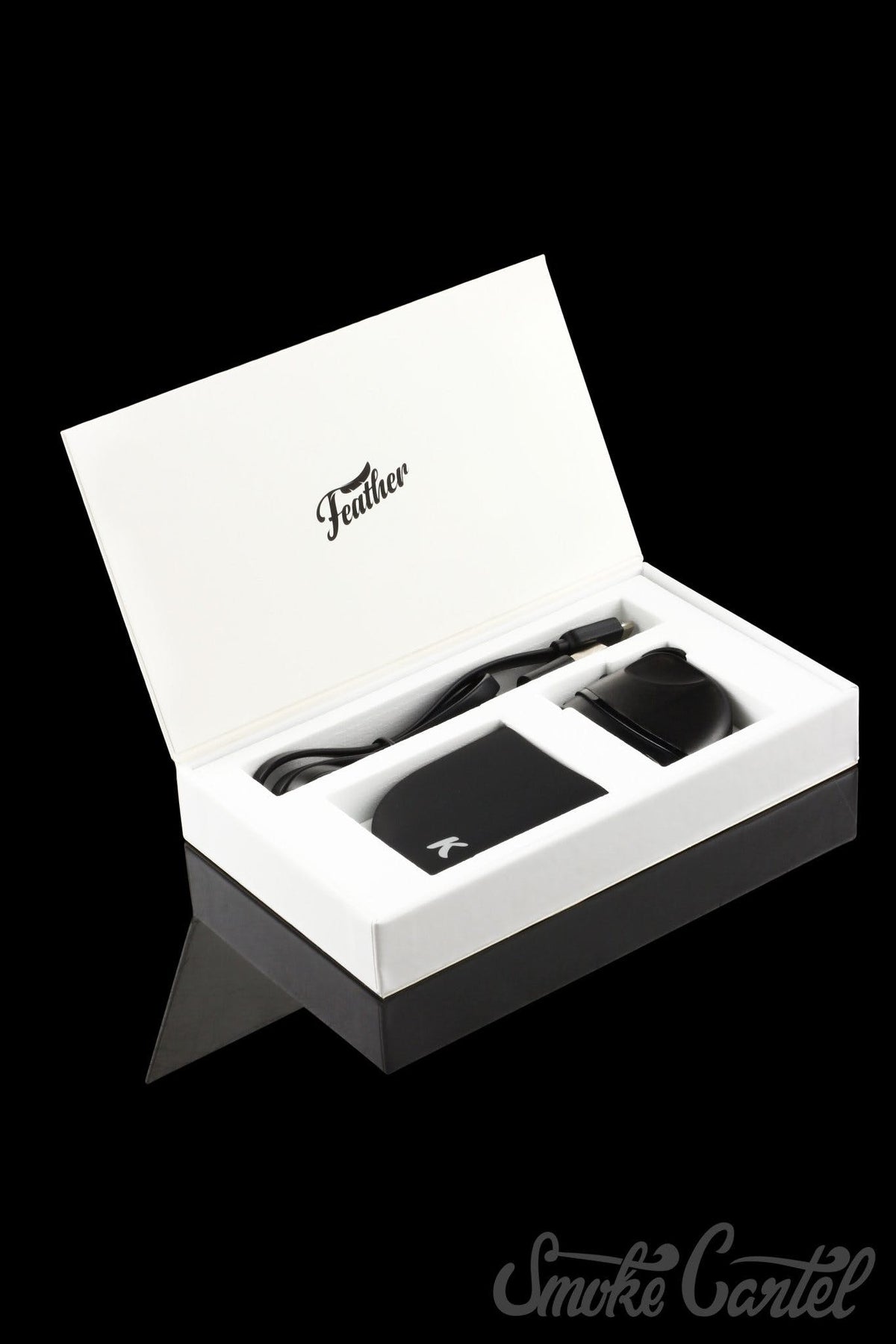 A top-down view of the open Kandy Pens Feather Compact Vaporizer box, displaying the device inside.