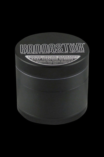 A close-up, angled view of the Kannastor Multi Chamber 4pc 2.2" Grinder, showcasing its metallic finish and multi-tiered construction.