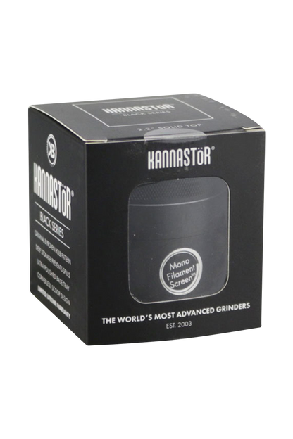 Close-up of the Kannastor Multi Chamber 4pc 2.2” Grinder against a black background, showcasing its multi-tiered design.