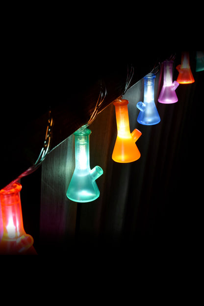 String lights shaped like glass bongs glowing in vibrant colors against a black background.
