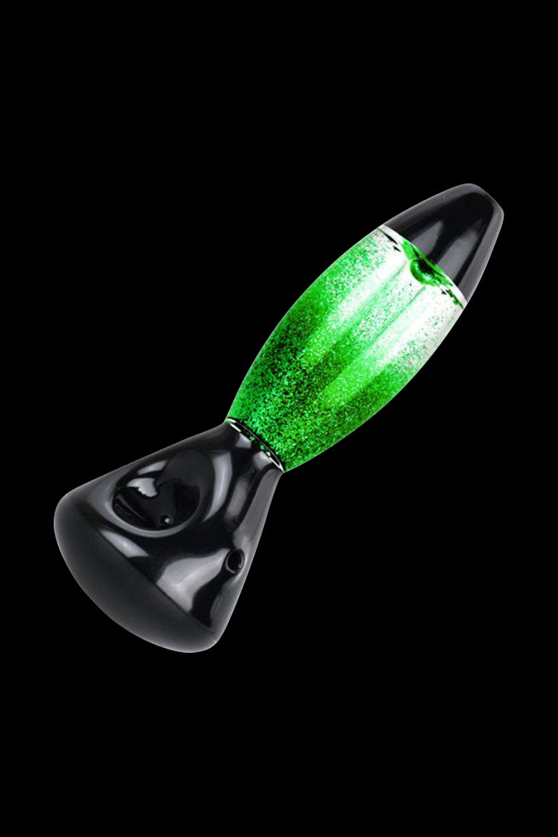 Green glitter-filled glass pipe on a black background.