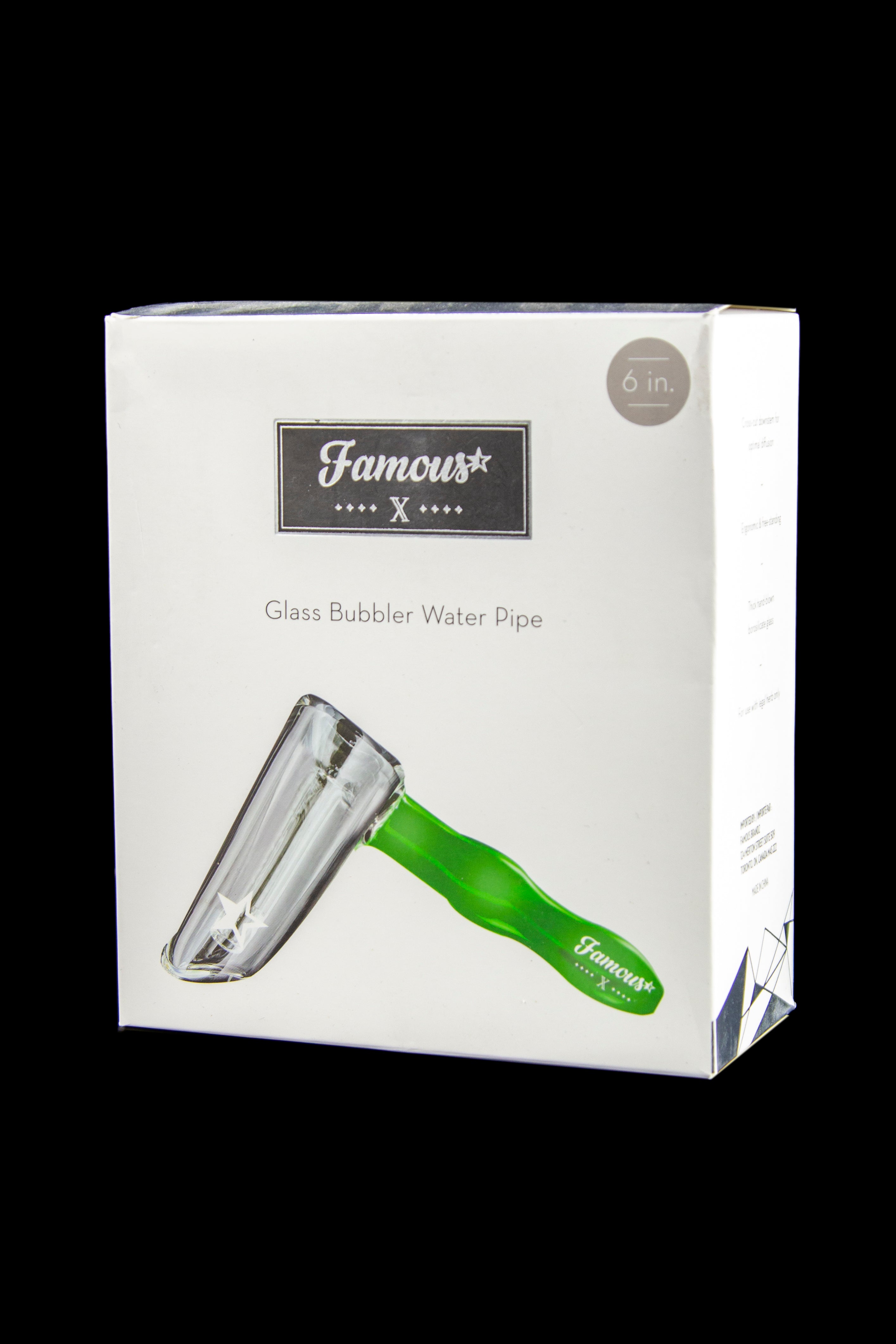 Boxed product front on black background showing a green-handled Famous X Straight Hammer Bubbler Pipe with the brand logo near the top.