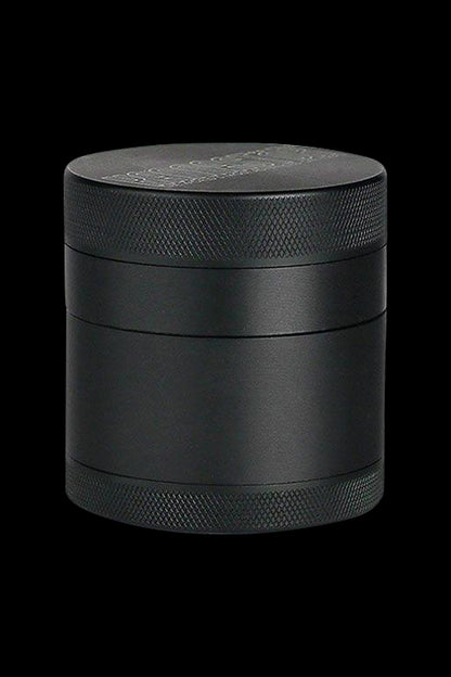 Front view of the Kannastor 4-Piece Solid Body Grinder, showcasing its metallic finish and cylindrical form.