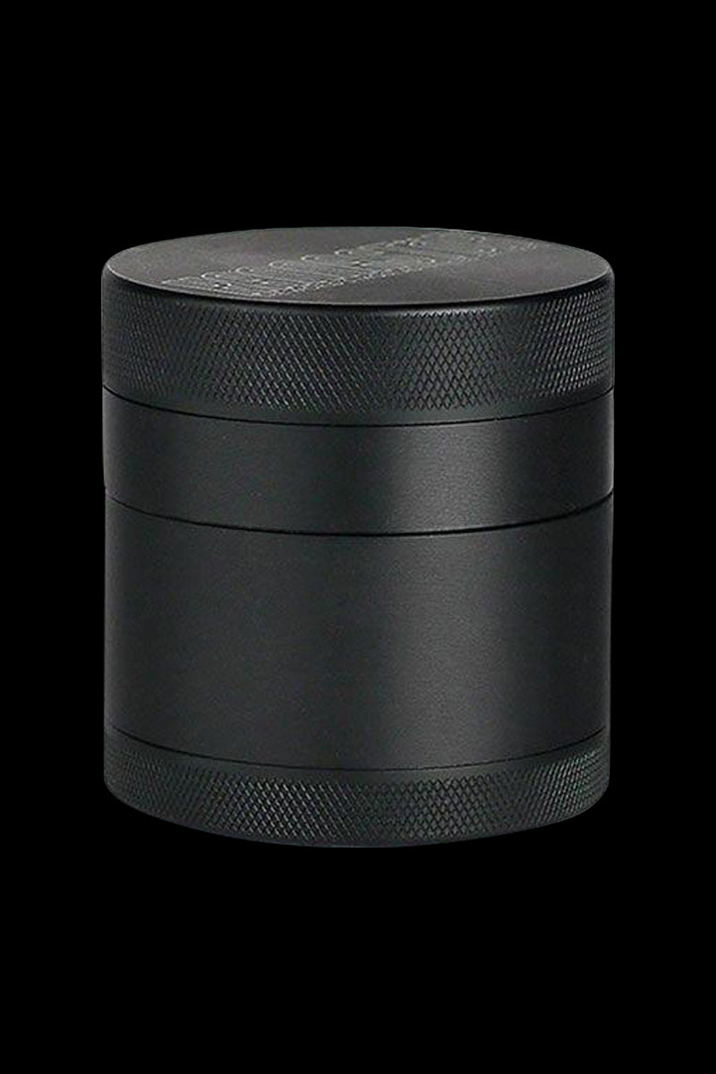 Front view of the Kannastor 4-Piece Solid Body Grinder, showcasing its metallic finish and cylindrical form.