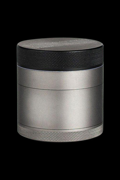 Front view of the Kannastor 4-Piece Solid Body Grinder, showcasing its metallic finish and cylindrical shape.