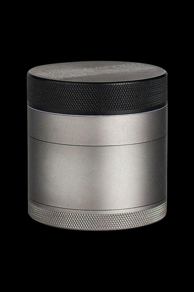 Front view of the Kannastor 4-Piece Solid Body Grinder, showcasing its metallic finish and cylindrical shape.