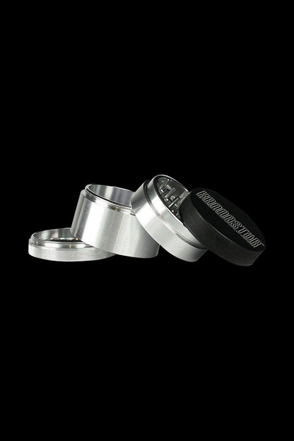 Close-up angled view of the Kannastor 4-Piece Solid Body Grinder, showcasing its metallic finish and multi-part construction.