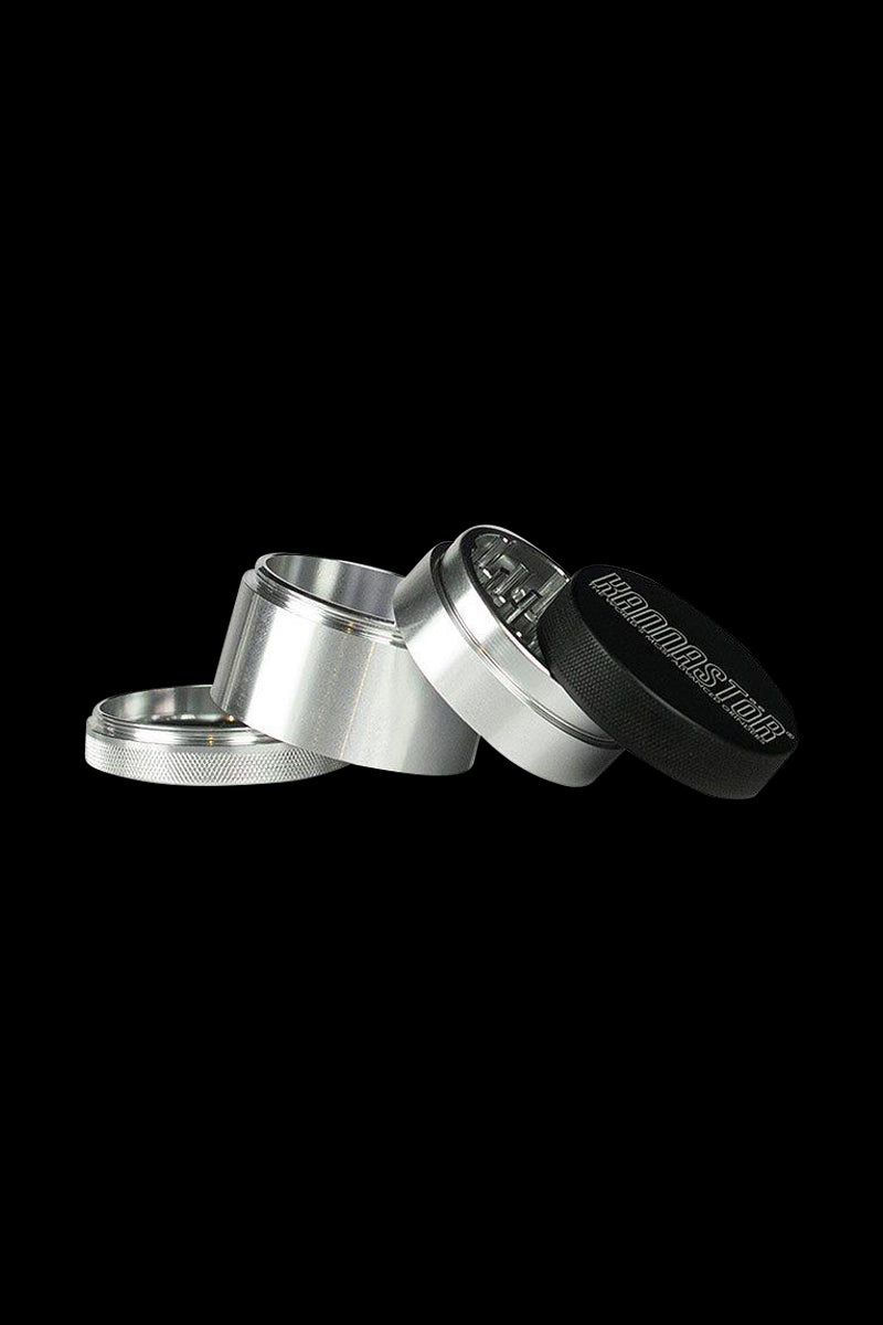 Close-up angled view of the Kannastor 4-Piece Solid Body Grinder, showcasing its metallic finish and multi-part construction.