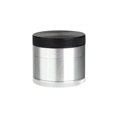 A close-up, angled view of the Kannastor 4-Piece Solid Body Grinder, showcasing its metallic finish and multi-tiered construction.