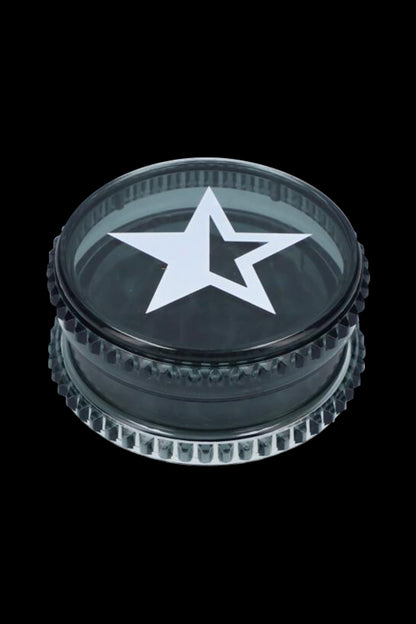 Black metal grinder with a white five-pointed star emblem.
