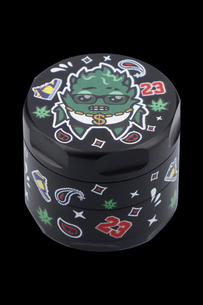 Black grinder with cartoon marijuana leaf character and dollar signs, decorated with red "23" and green cannabis leaves.