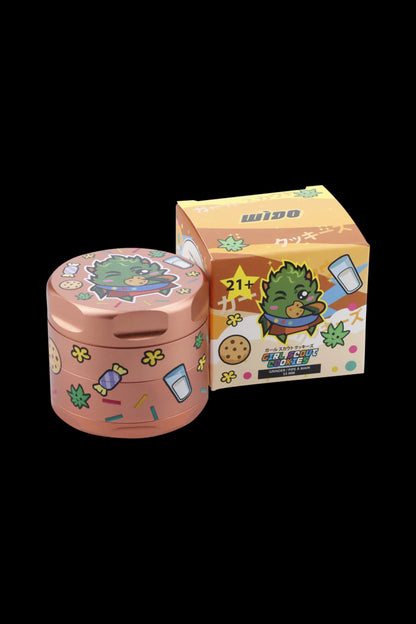 Pink and yellow grinder with a cartoon duck illustration and “Girl Scout Cookies” branding, alongside a matching storage container.