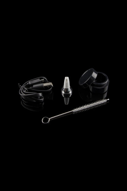 Cannabis vape pen accessories including a charging cable, mouthpiece, carrying case, and cleaning brush, arranged on a black background.
