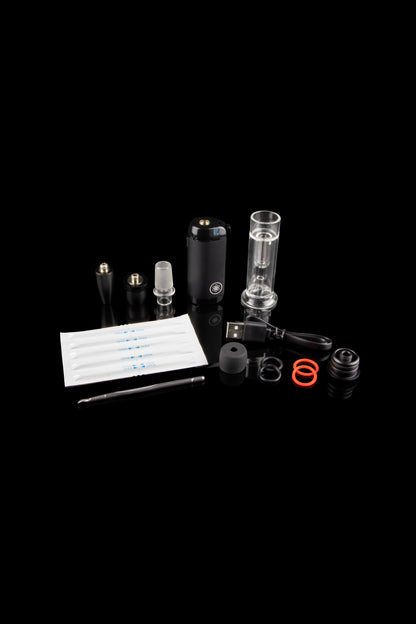 Cannabis vaporizer kit with device, glass bubbler, and accessories on a dark background.