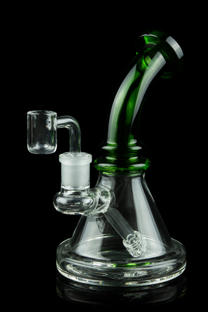 Green and clear glass dab rig with a quartz banger, isolated on a black background.