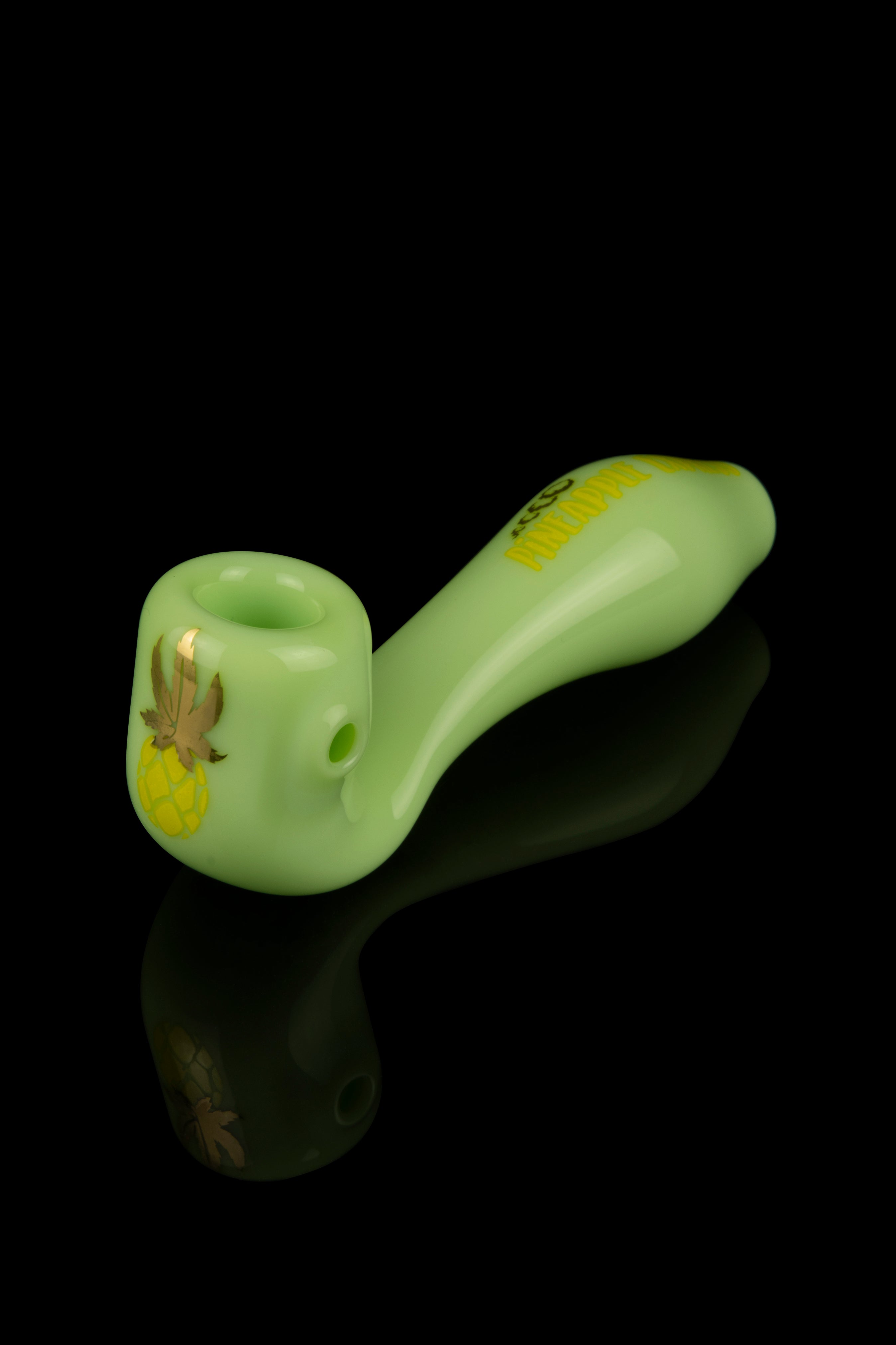 Green glass pipe with gold cannabis leaf detail and reflective surface.