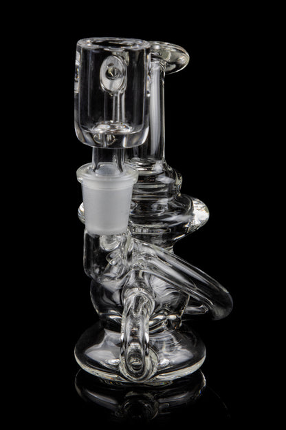 Clear glass water pipe (bong) with intricate curves and a removable downstem, isolated on a black background.