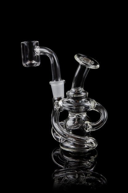 Clear glass dab rig with intricate looping design, against a black background.