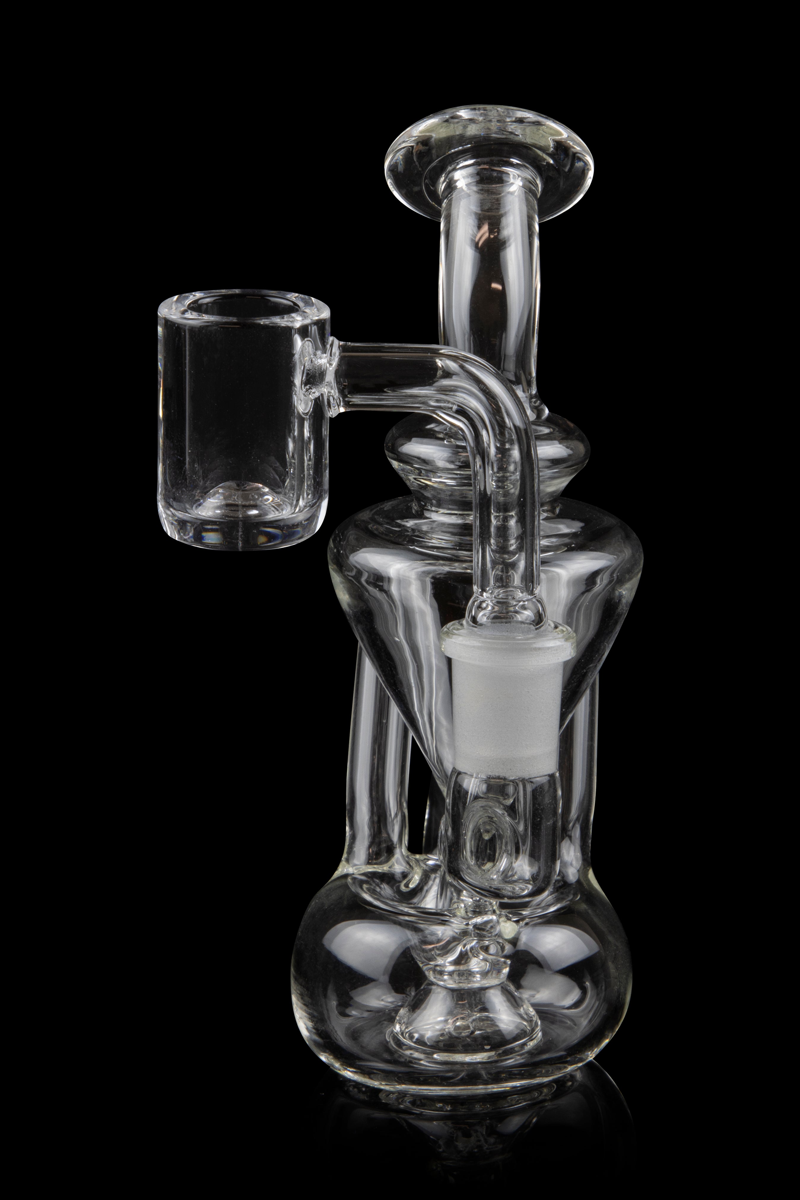 Clear glass dab rig with a quartz banger, isolated on a black background.