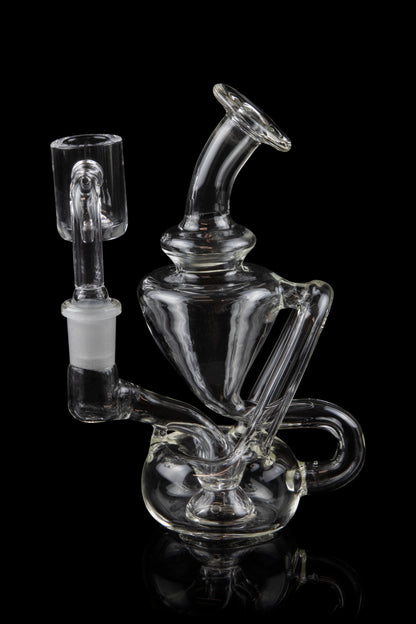 Clear glass water pipe (rig) with intricate bubbler design and separate bowl piece, isolated on black.