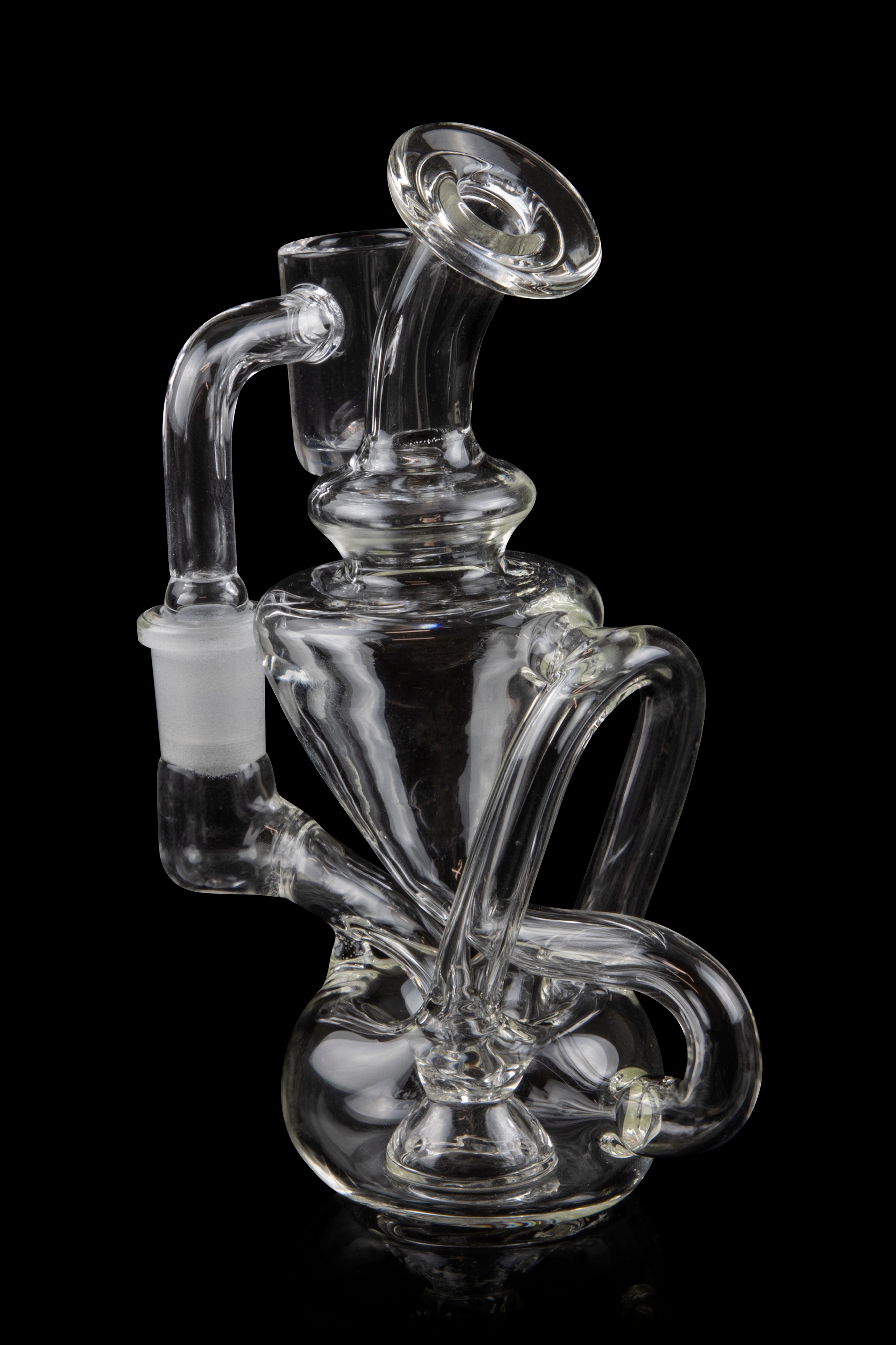 Clear glass water pipe (rig) with intricate swirling design, isolated on a black background.