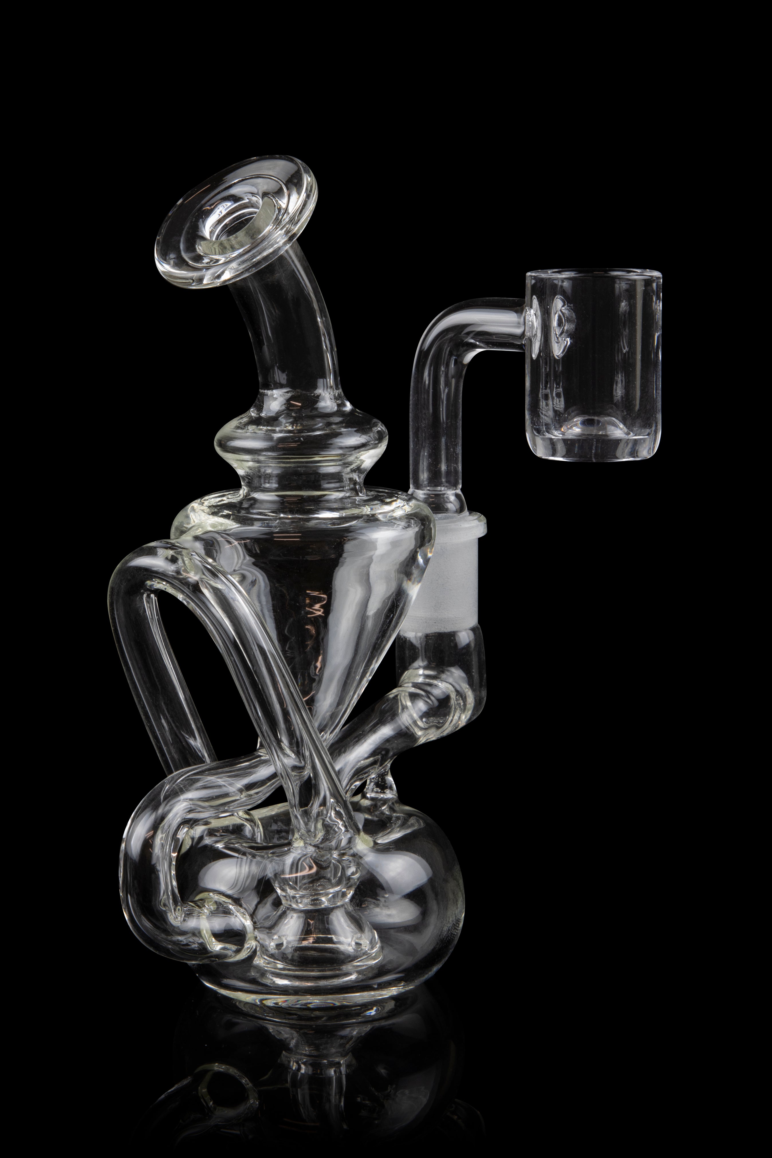 Clear glass dab rig with intricate bubbler design and quartz banger, isolated on black.