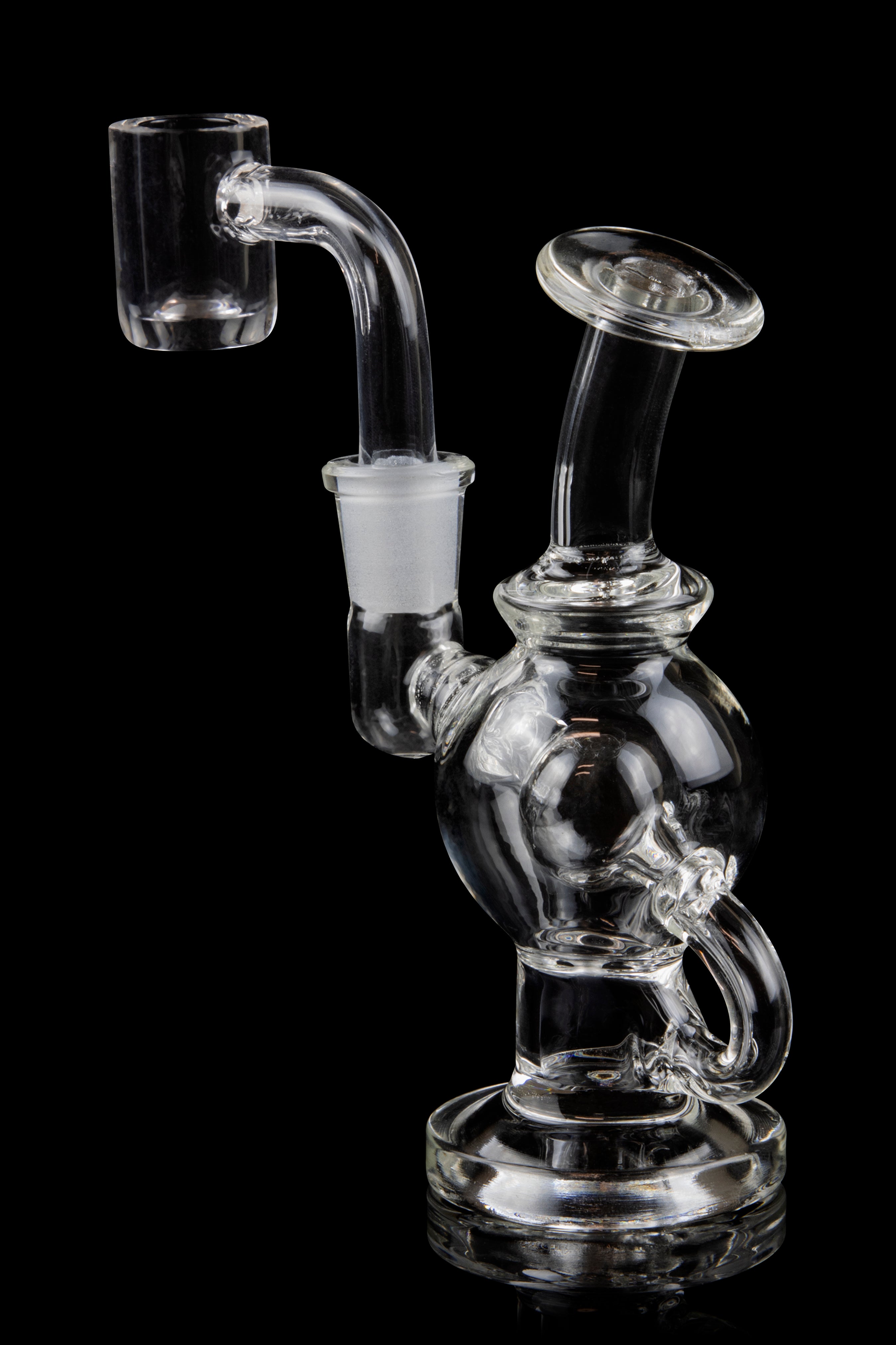 Clear glass dab rig with a quartz banger, isolated on a black background.