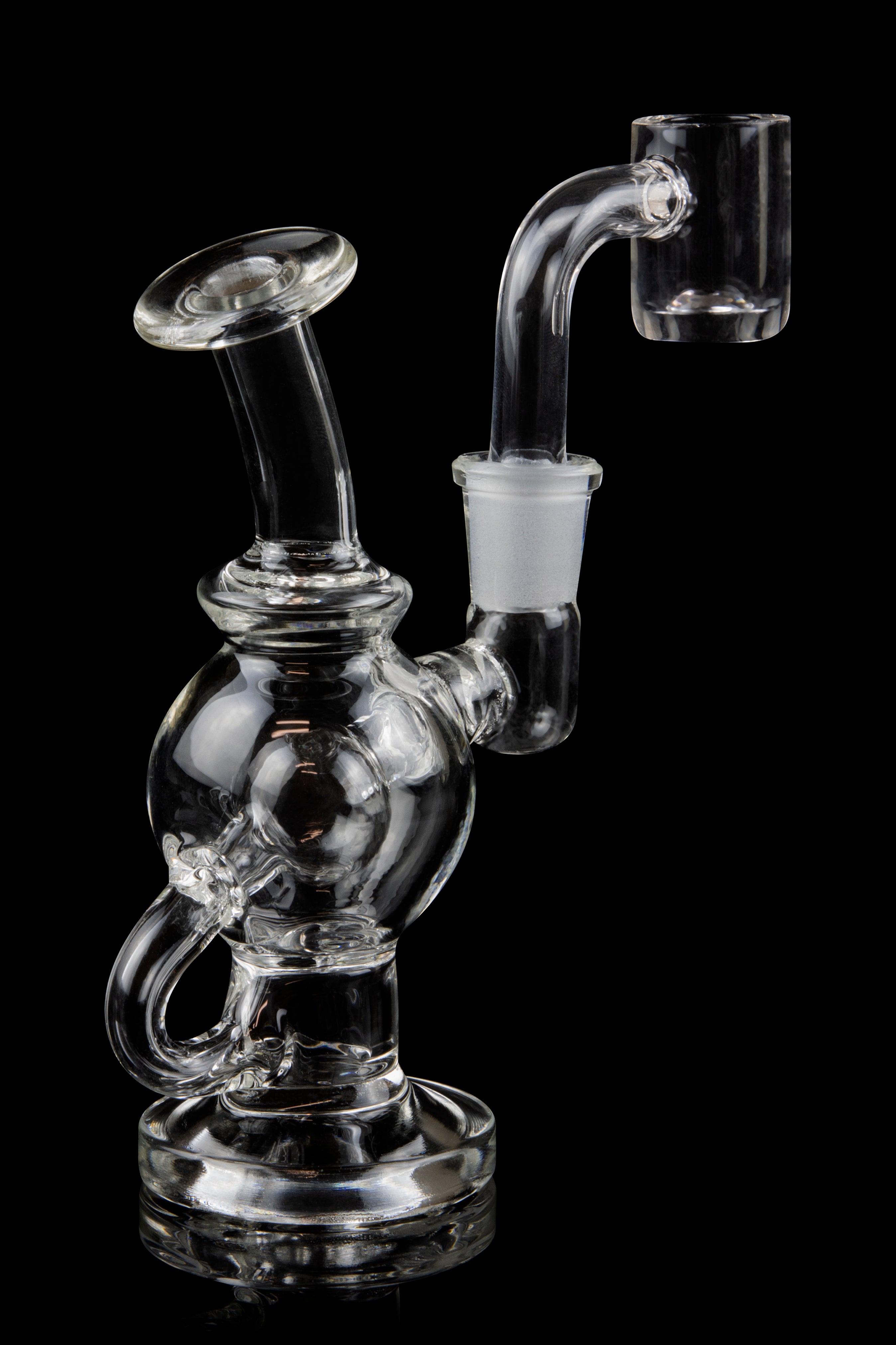 Clear glass dab rig with quartz banger, isolated on black.