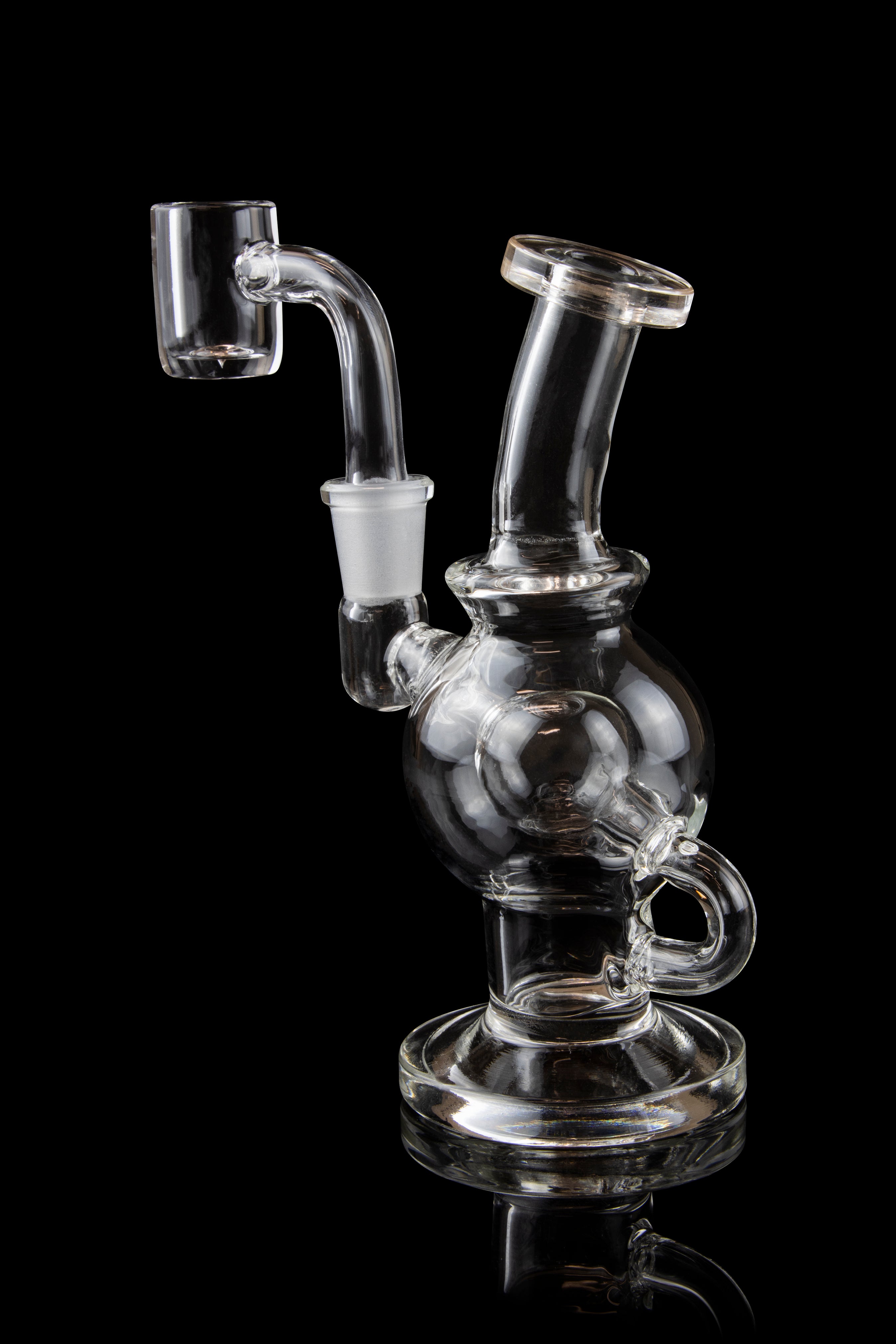 Clear glass dab rig with a bubbler and quartz nail, isolated on black.