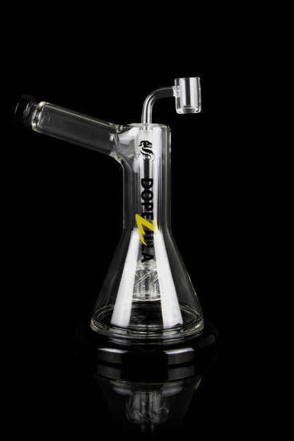 Clear glass oil rig with a dab nail and intricate internal diffusion, reflecting on a black surface.