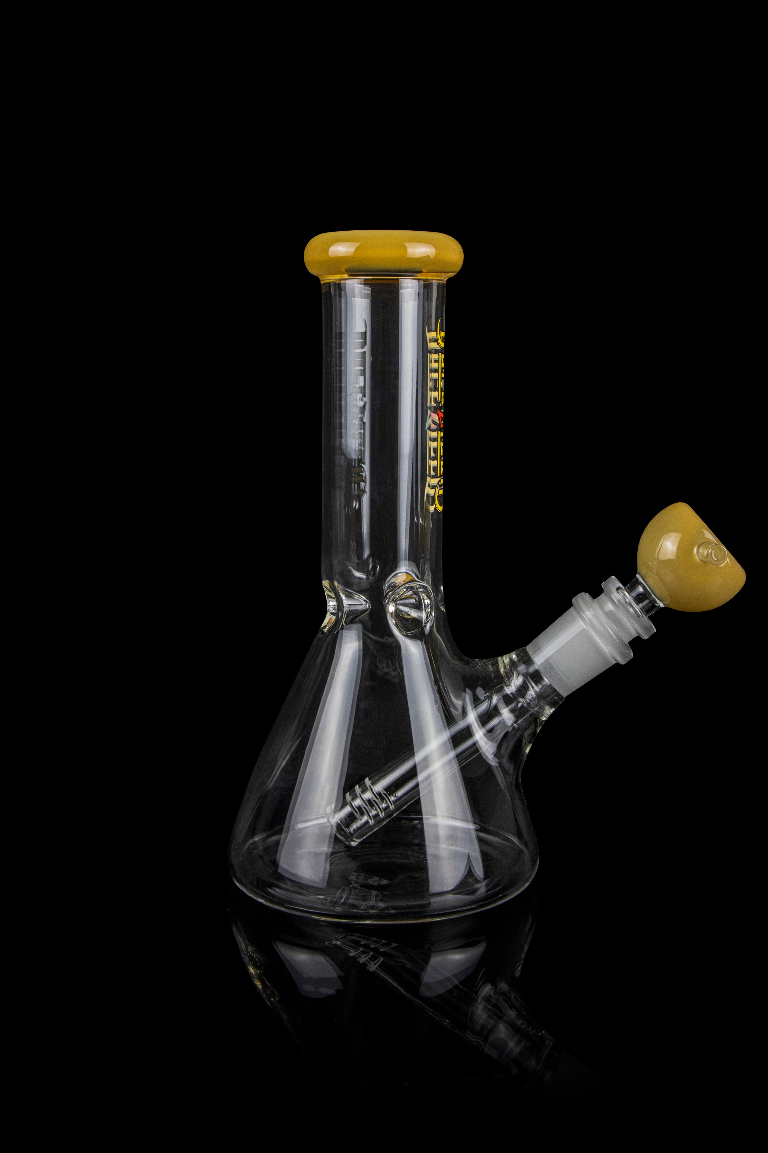 Clear glass water pipe (bong) with a flared base and amber-colored accents, isolated on a black background.