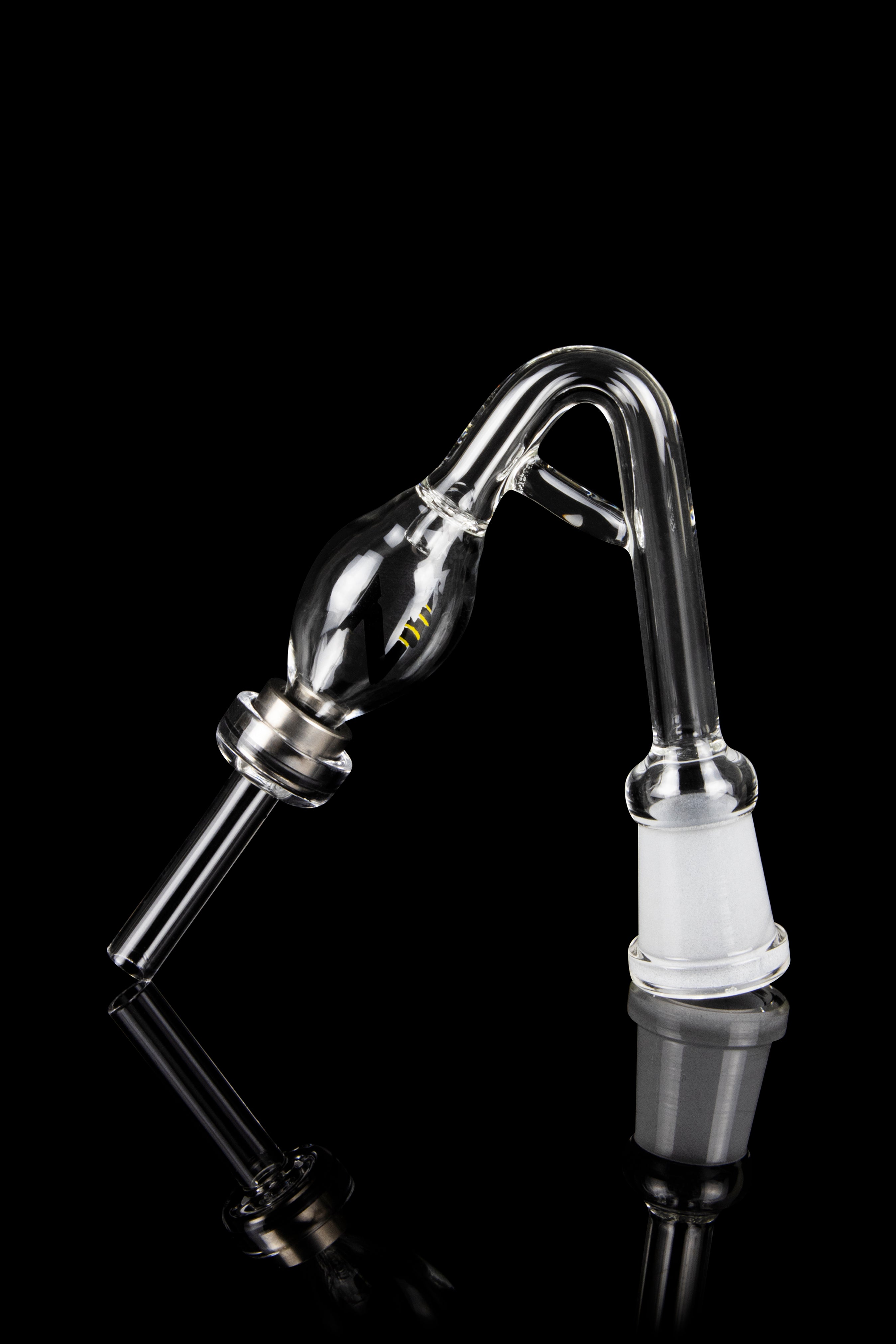 Clear glass oil rig attachment with a rounded reservoir and angled mouthpiece, reflecting on a black surface."