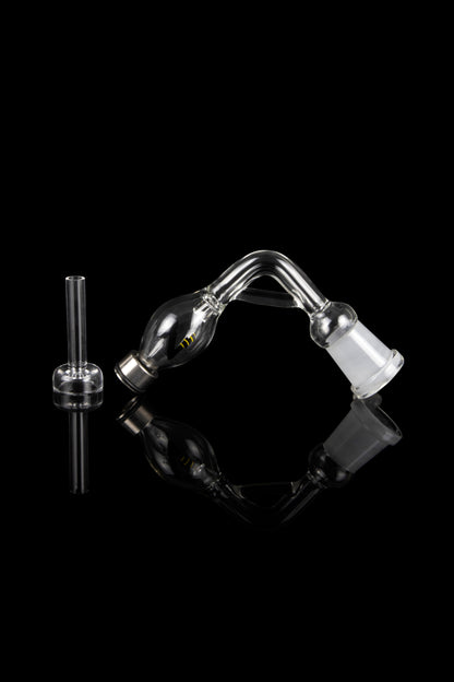 Glass bubbler and downstem against a black reflective surface.