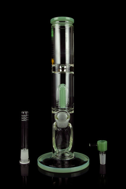 Green glass bubbler water pipe with detachable downstem and mouthpiece, reflecting on a dark surface.