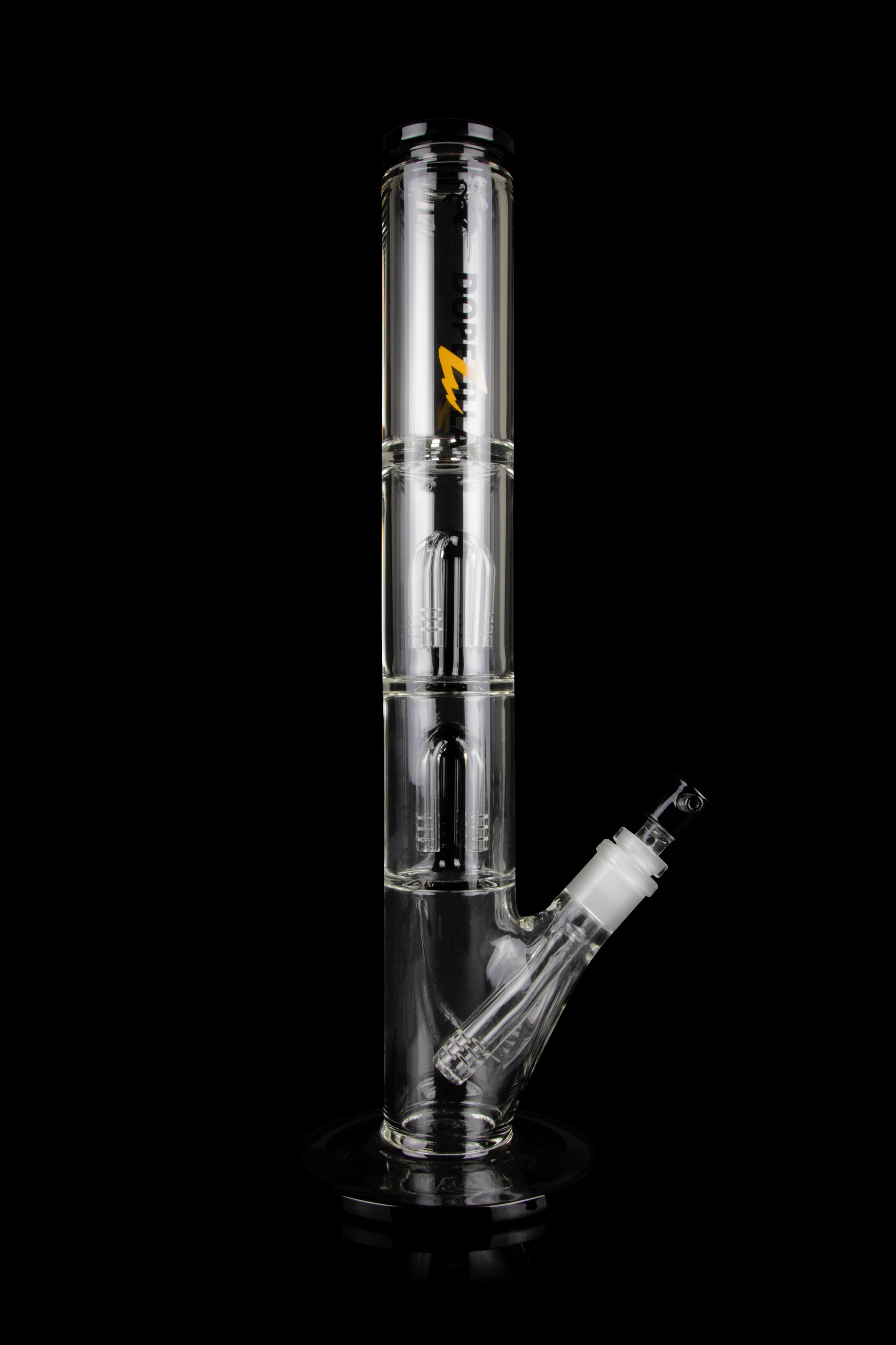 Clear glass bong with multiple chambers and a detachable downstem, isolated on a black background.