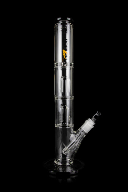 Clear glass bong with multiple chambers and a detachable downstem, isolated on a black background.