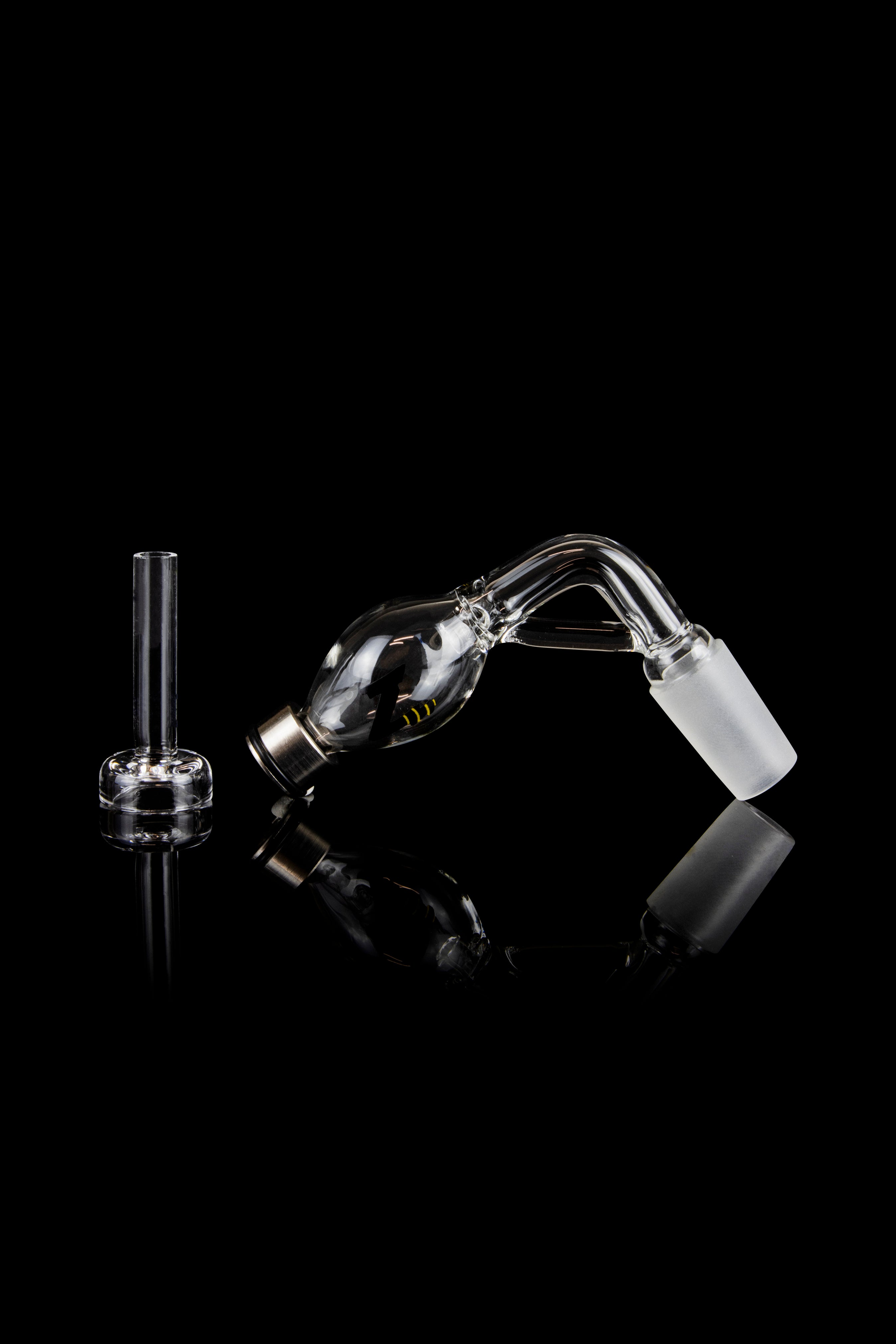 Glass bubbler and mouthpiece for cannabis use, studio shot on black.