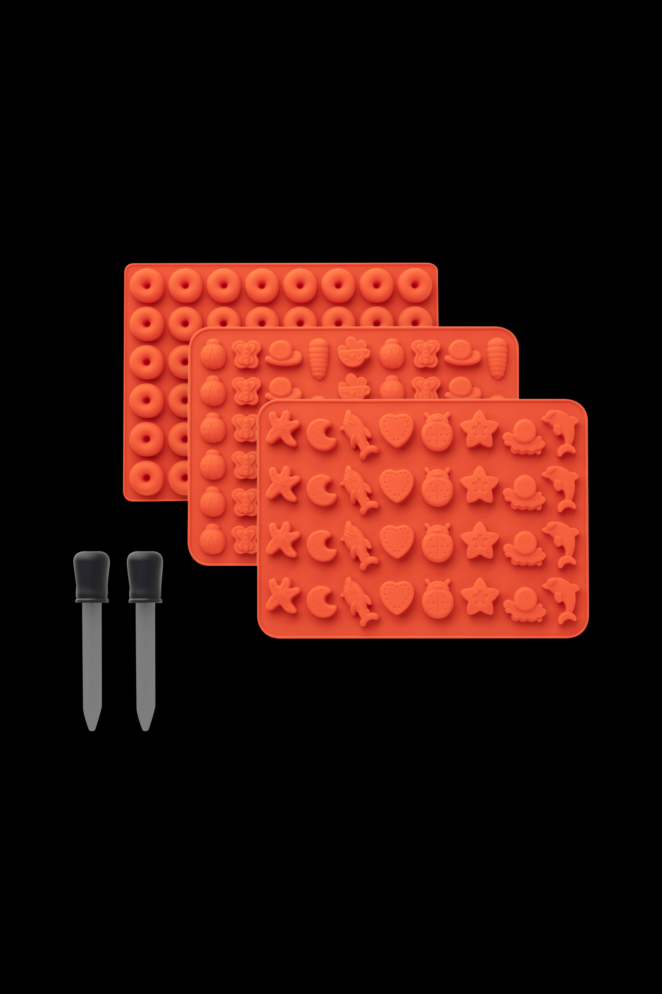 Red silicone molds with various cannabis-themed shapes and two dab tool applicators on a black background.