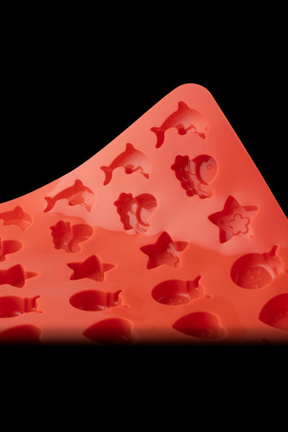 Red silicone mold with various animal shapes, likely for making cannabis edibles.