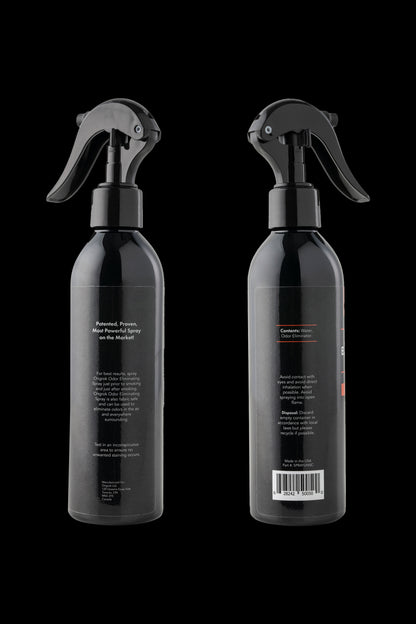 Two black spray bottles labeled “OdorX” for eliminating cannabis smells, positioned against a dark background. The labels detail usage instructions and safety precautions.