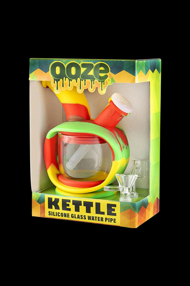A front view of the Ooze Kettle Silicone Water Pipe, displayed in its packaging with a vibrant, colorful design.