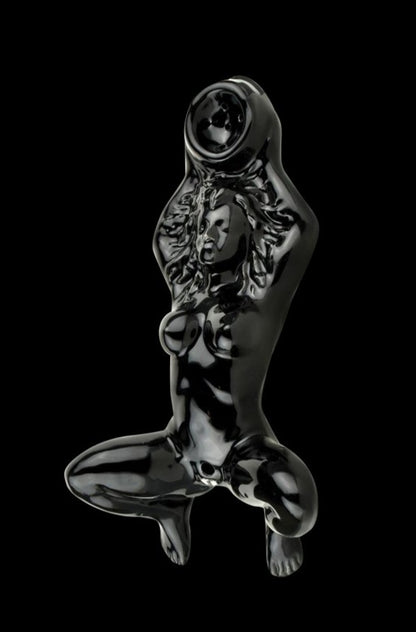 A detailed side view of the Oracle at Delphi Priestess Ceramic Hand Pipe, showcasing its sculpted form and smooth, dark finish.